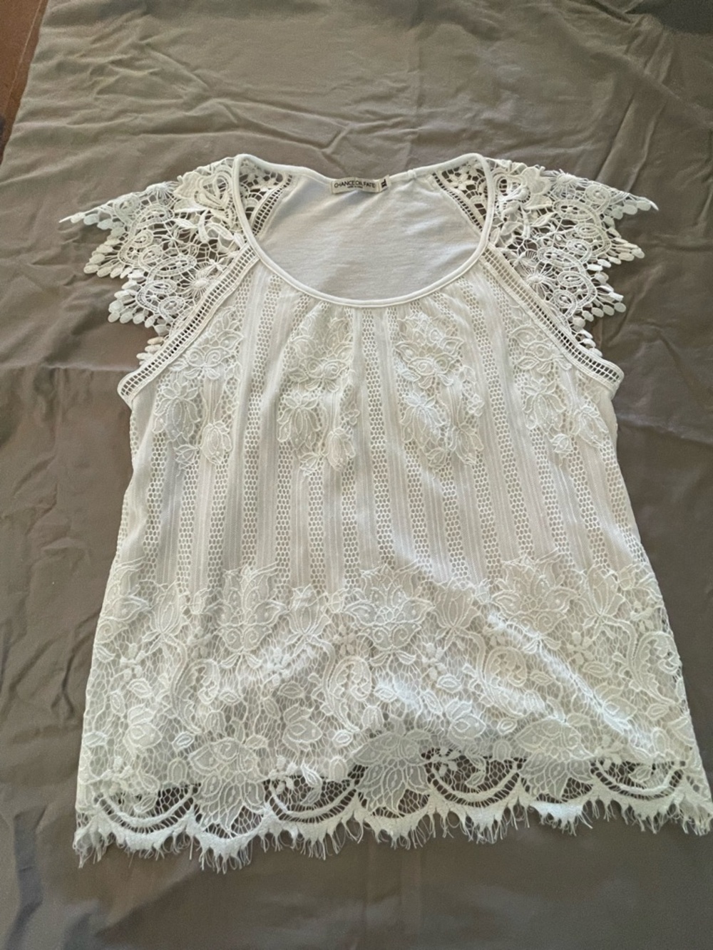 XL barely off white top with lace appearing accent.